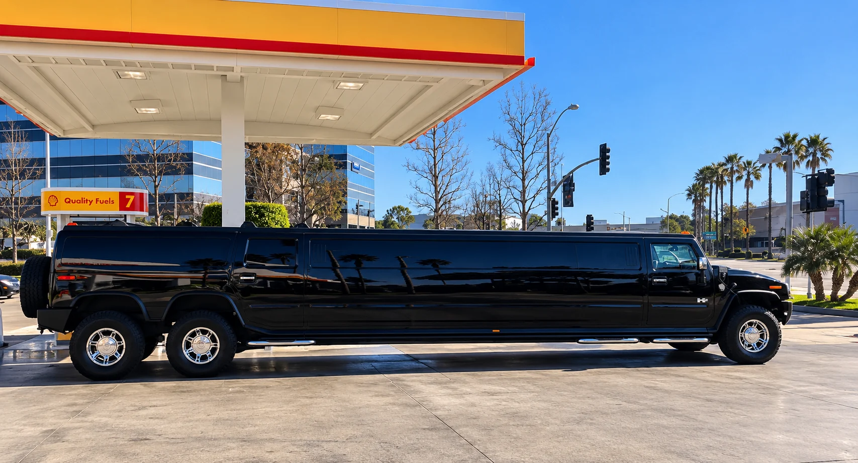Black dual-axle H2 Hummer limousine side profile on a sunny Southern California day