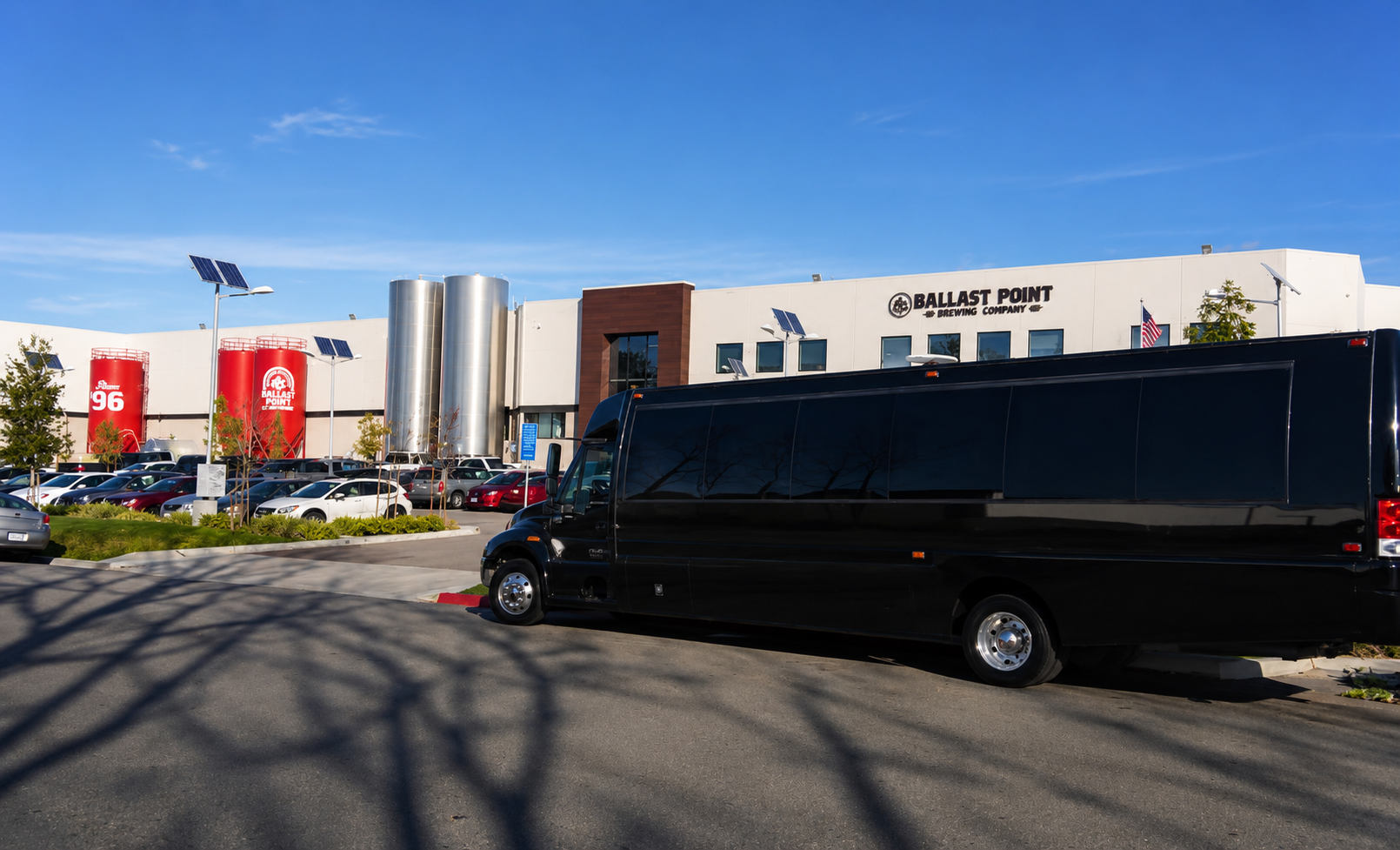 Black party bus parked outside Ballast Point Brewing during a brewery and winery tour