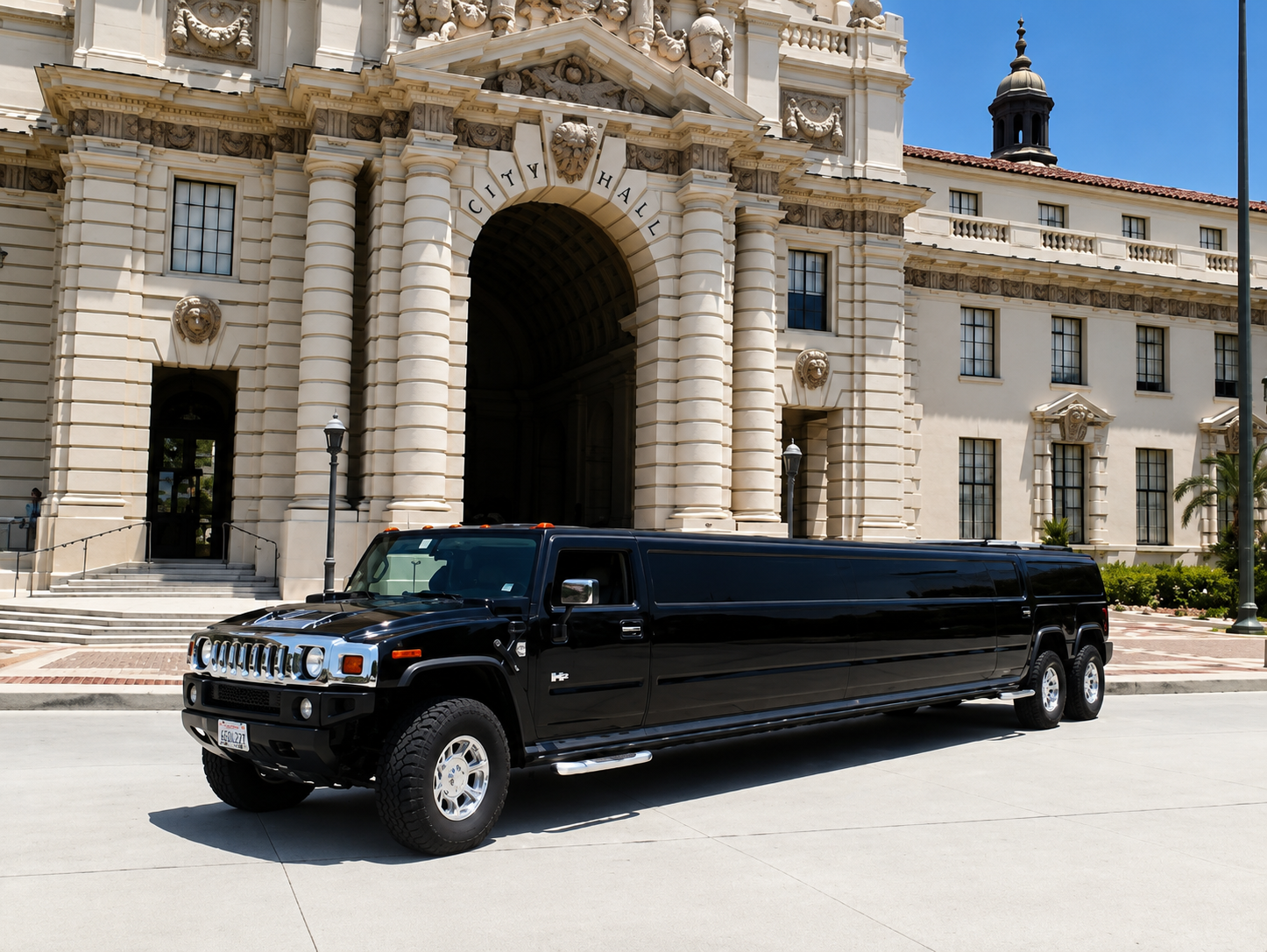 Black stretch Hummer H2 limousine parked in front of a historic California city hall