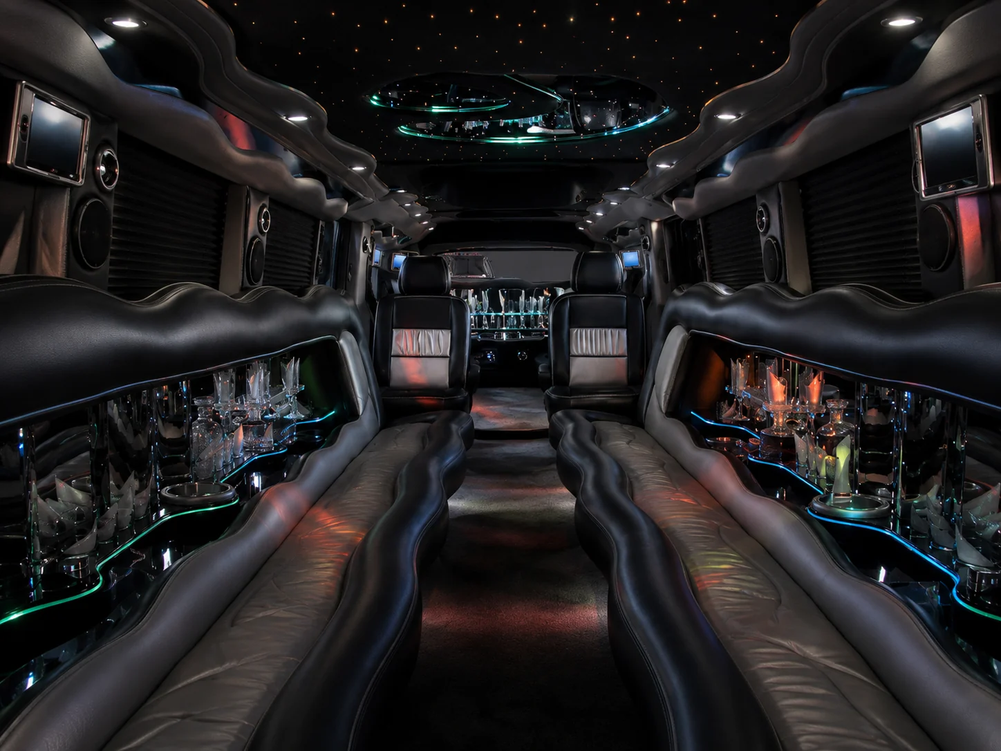Dual axle H2 Hummer limousine interior with lounge seating and bar
