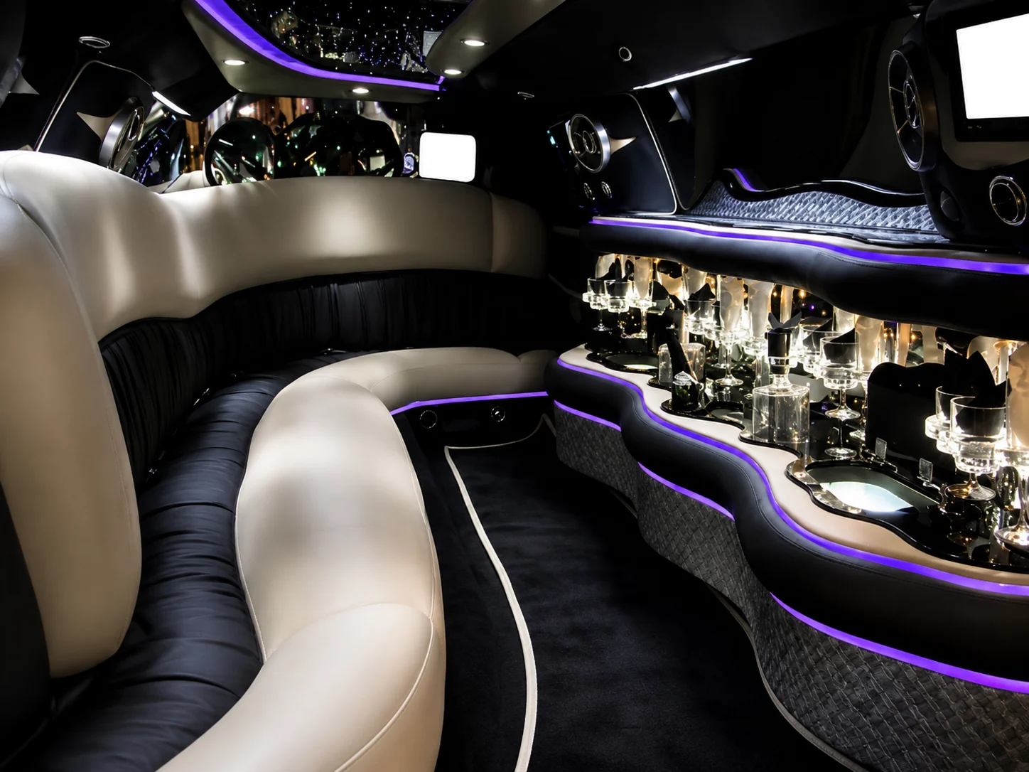 Silver Mercedes S550 limo interior with lounge seating and bar