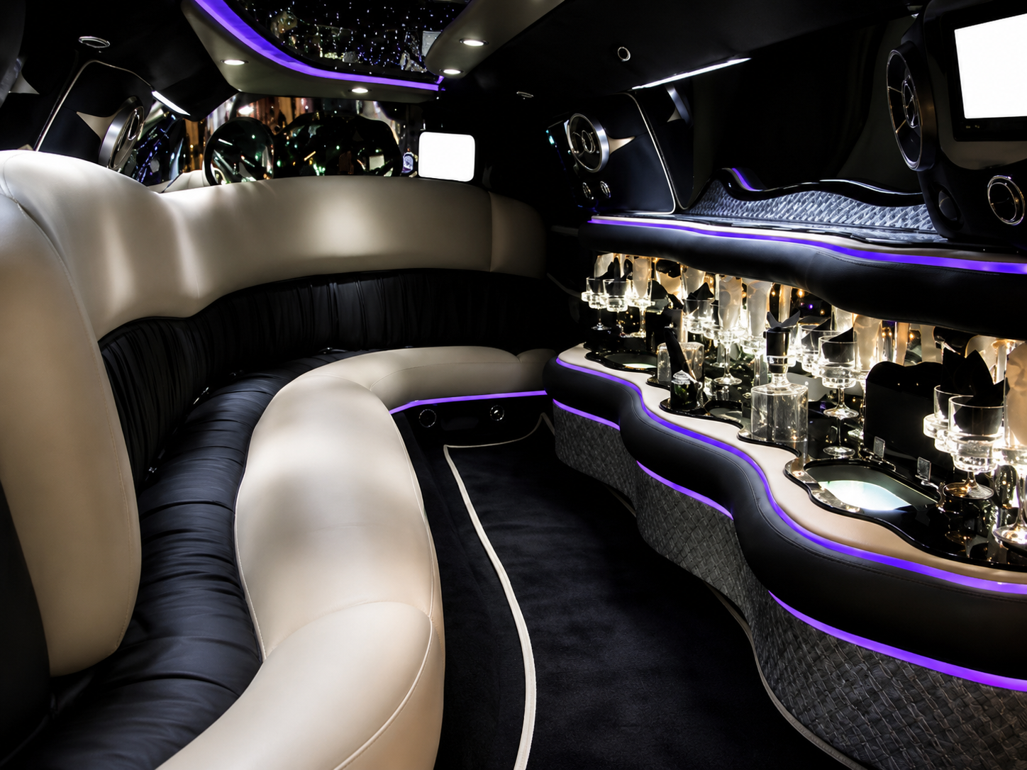Silver Mercedes S550 limo interior with lounge seating and bar