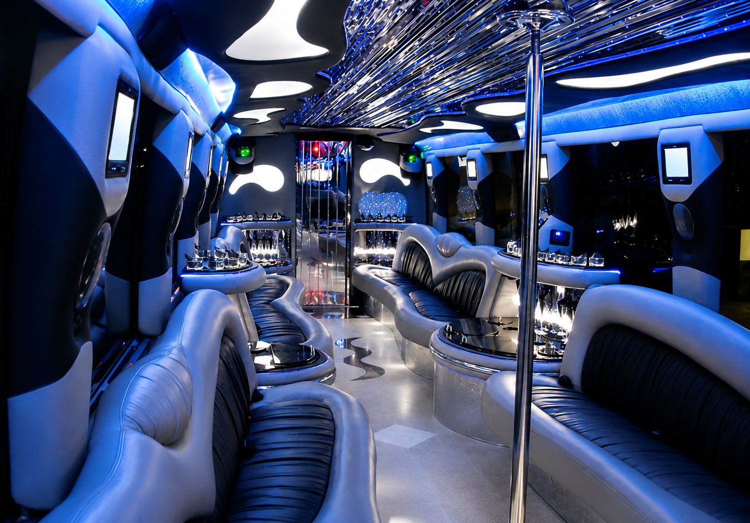 Luxury coach party bus interior with blue LED lighting, dance pole and full bar